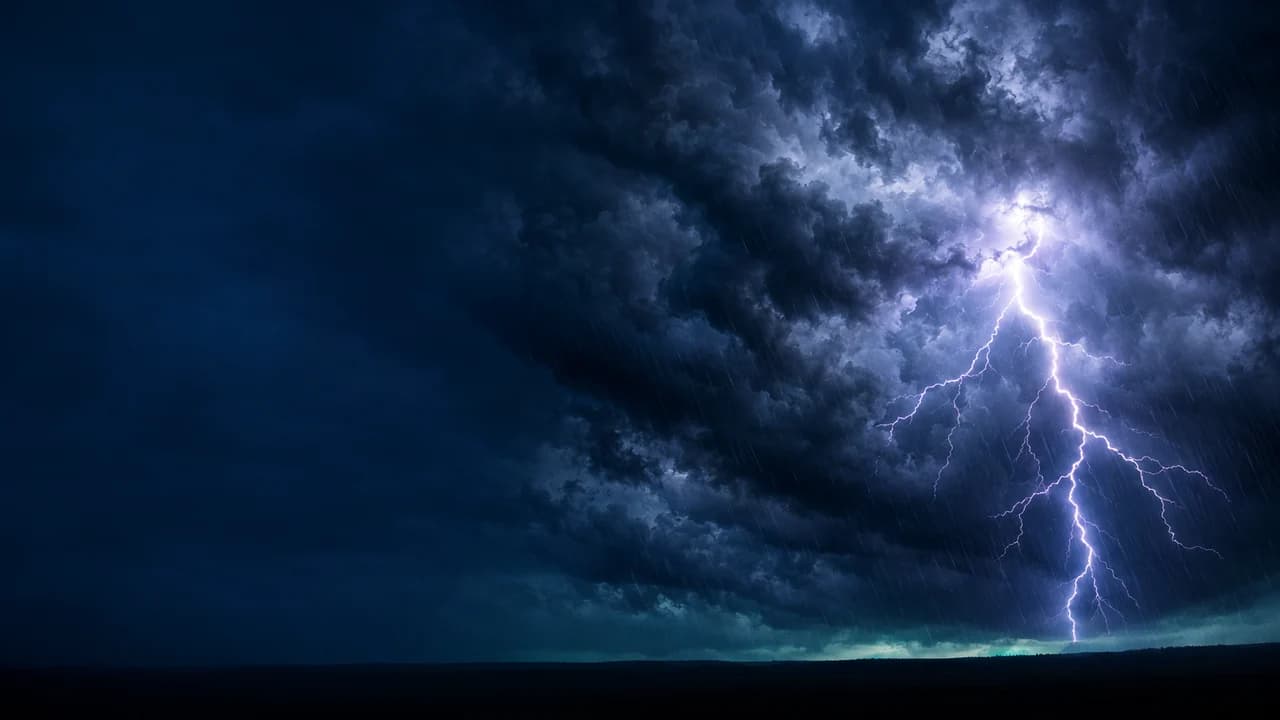 Dark storm clouds with a lightning bolt in the distance on the right, smooth dark blue sky on the left.